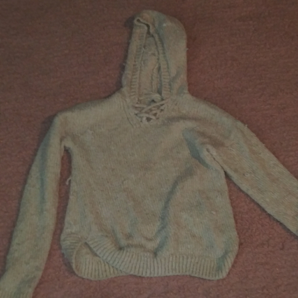 Knitted sweater with pulled out threads